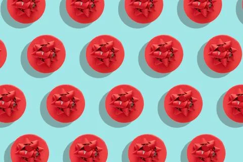 Pattern red gift box with decorative bow on blue surface top view flat lay. H Stock Photos