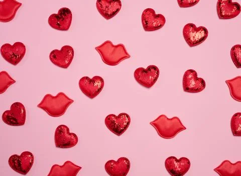 Pattern of red glitter hearts and lip appliqus randomly placed on a pink ba.. Stock Photos