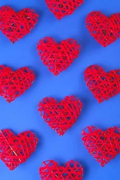 Pattern of the red hearts on the cornflowerblue background. Stock Photos