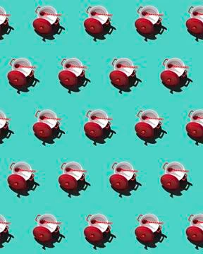 Pattern with red pan and ceramic spoon on a turquoise background Stock Photos
