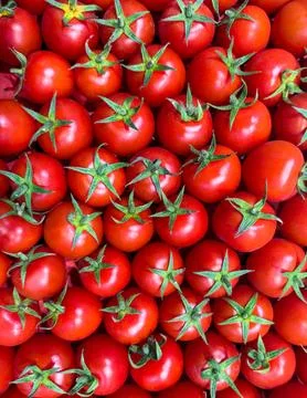 Pattern of red small cherry tomatoes. Top view of fresh organic vegetables Stock Photos