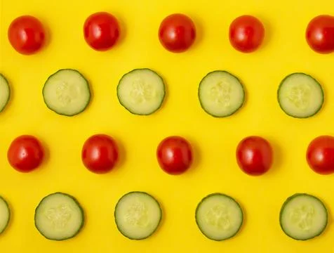Pattern red tomato and green cucumber on a yellow background Stock Photos