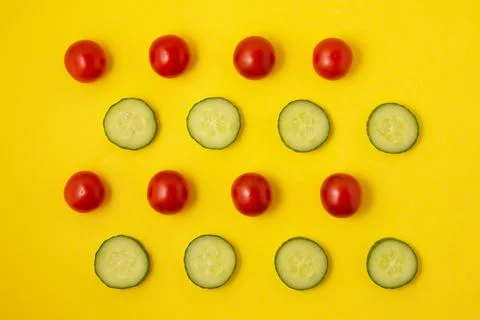 Pattern red tomato and green cucumber on a yellow background Stock Photos