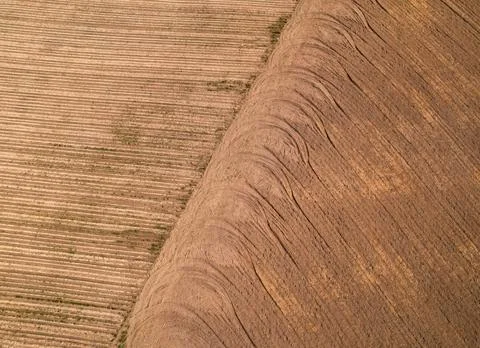 Pattern of repeating wheel tread marks on a plowed field. Stock Photos
