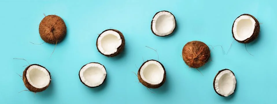 Pattern with ripe coconuts on blue background. Top View. Copy Space. Pop art Stock Photos