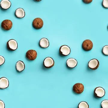 Pattern with ripe coconuts on blue background. Square crop. Top View. Copy Space Stock Photos