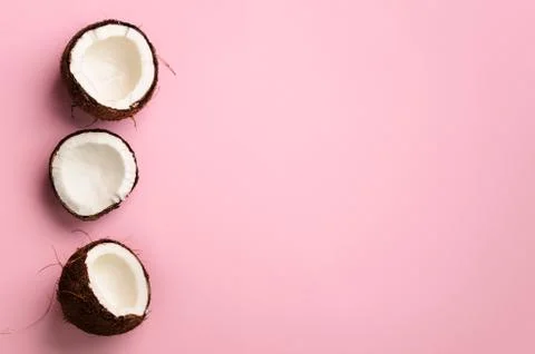 Pattern with ripe coconuts on pink background. Top View. Copy Space. Pop art Stock Photos