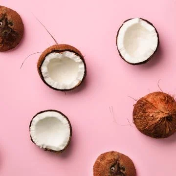 Pattern with ripe coconuts on pink background. Top View. Copy Space. Square crop Stock Photos