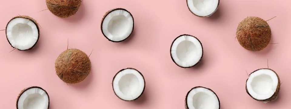 Pattern with ripe coconuts on pink background. Top View. Copy Space. Pop art Stock Photos