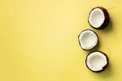 Pattern with ripe coconuts on yellow background. Top View. Copy Space. Pop art Foto stock