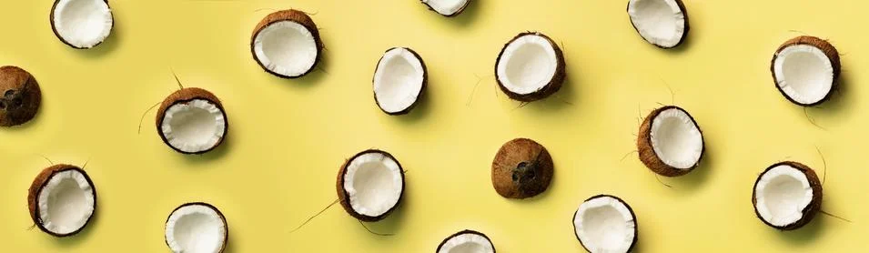 Pattern with ripe coconuts on yellow background. Top View. Copy Space. Pop art Foto stock
