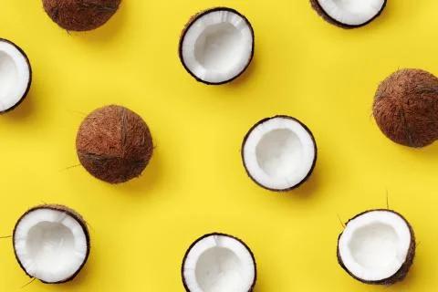 Pattern with ripe coconuts on yellow background. Pop art design, creative summer Stock Photos