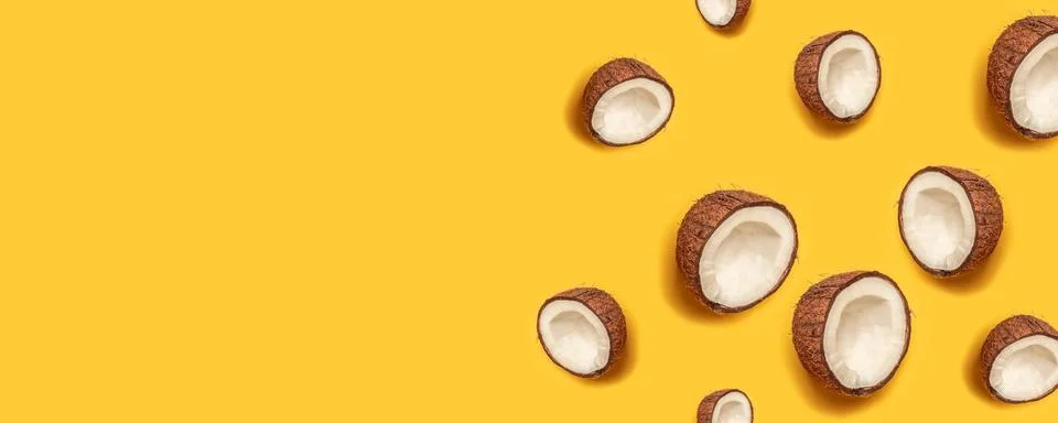 Pattern with ripe coconuts on yellow background. Stock Photos