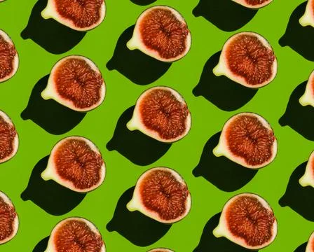 Pattern of ripe figs in a cut on a green background. Stock Photos