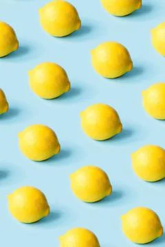Pattern of ripe lemons on a blue background. Stock Photos