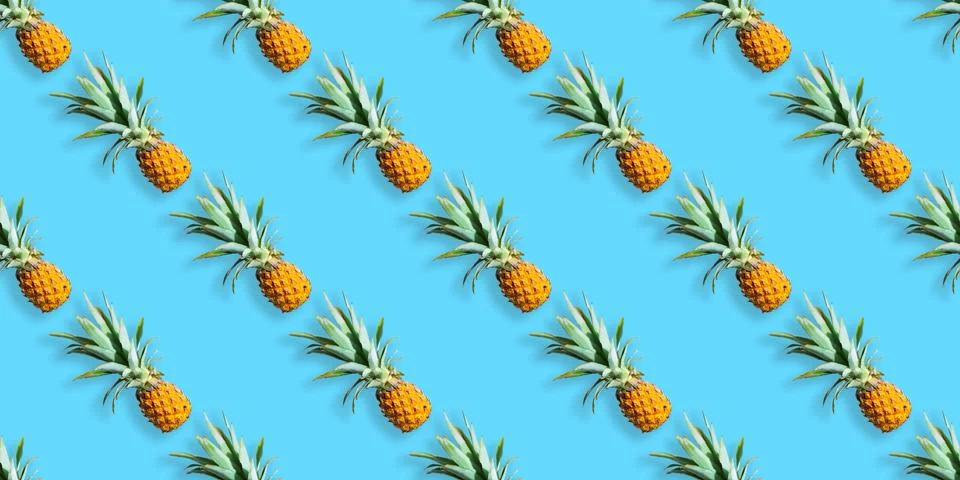 Pattern of ripe pineapples isolated on blue background. Seamless pattern Stock Photos