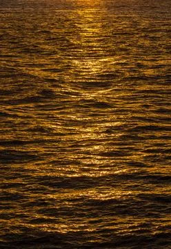 Pattern of ripples in the ocean reflecting sun Sunset or sunrise over the ... 스톡 사진