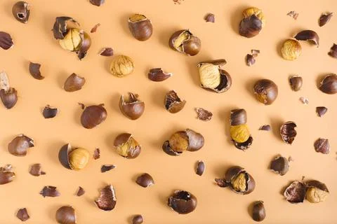 Pattern of roasted chestnuts on a brown background Stock Photos