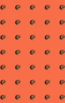 A pattern of roasted coffee beans on a brown background. Grocery pattern. Stock Photos