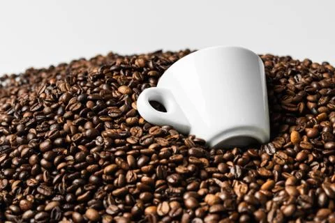 Pattern of roasted coffee beans with two white coffee cups Stock Photos