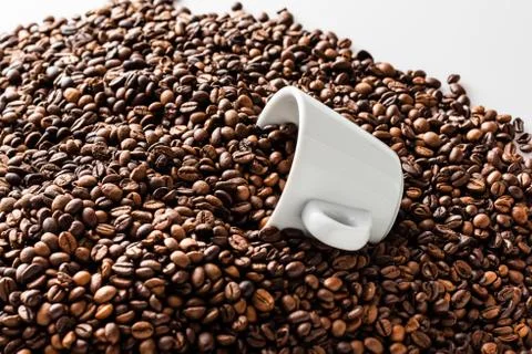 Pattern of roasted coffee beans with two white coffee cups Stock Photos