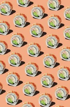 Pattern of rolls with prawn fillet on pinkish orange background Stock Photos