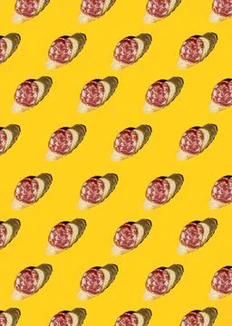 Pattern with salami sandwich on yellow background Stock Photos