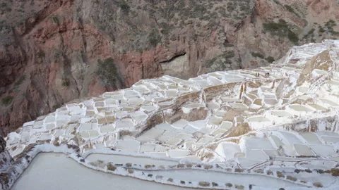 Pattern of salt terraces at Maras salt mines in the Peruvian Andes mountains Stock Footage 202346332