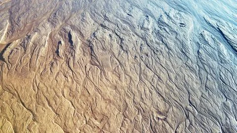 Pattern on the sand after waves. Stock Photos