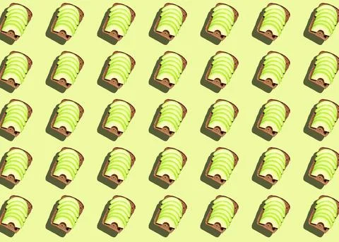 A pattern of a sandwich with sliced avocado. Stock Photos