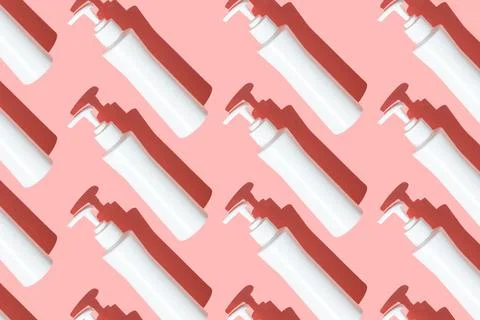 Pattern sanitizer tubes on pink table flatlay. Fabric medical production Stock Photos