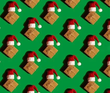 Pattern of Santa hat on paper gift box present on green background. Copy sp.. 写真素材