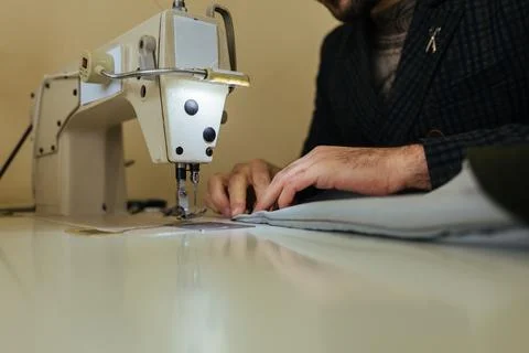 Pattern, scissors, tape measure, and a sewing machine. Workplace of seamstr.. Stock Photos