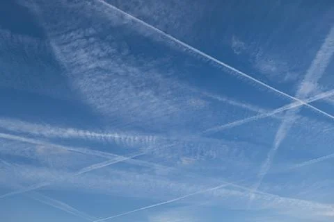 Pattern of several aircraft contrails in the blue sky Stock Photos