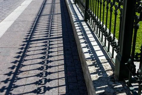 Pattern from shaped contrasting shadow from vintage fence Stock Photos