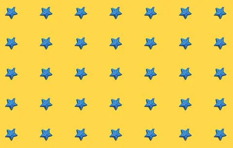 A pattern with shiny blue star-shaped decorations for New Year and Christmas. Stock Photos