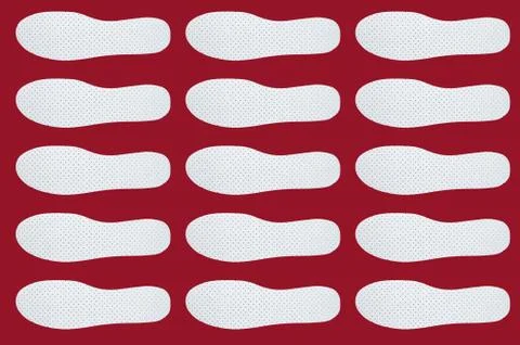 Pattern with Shoe insoles on a red background. 库存照片