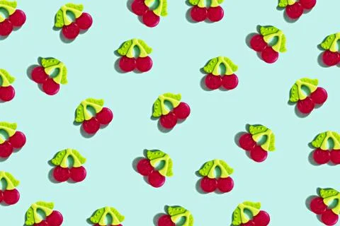 Pattern of silicone toys teether in the shape of cherry on blue background Stock Photos