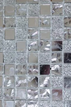 Pattern of silver and mirror square tiles on the wall Stock Photos