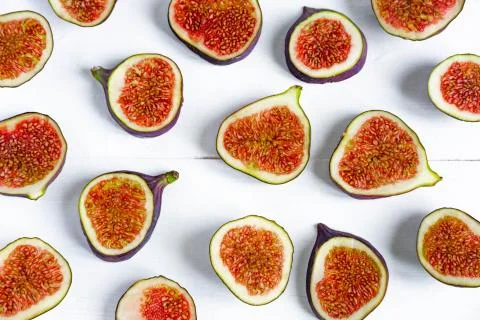 Pattern of sliced figs on a white background. Close-up photo of chopped figs Stock Photos