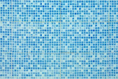 Pattern of small blue and white tiles in harmonic structure like a swimming.. Stock Photos