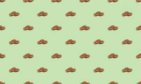 Pattern of small brown cookies on light green background Stock Illustration