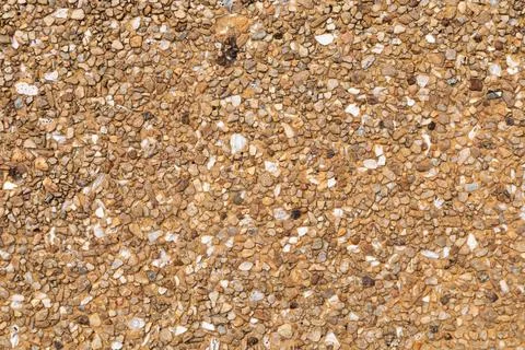 The pattern small brown pebbles stone as background. pebbles texture wall a.. Stock Photos