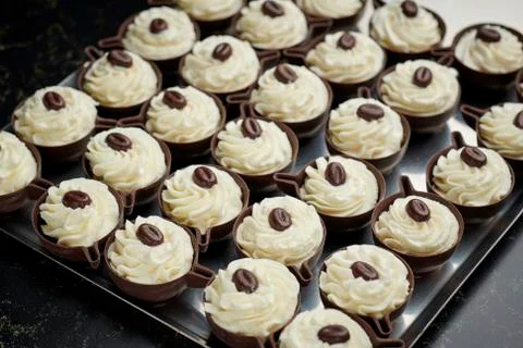 Pattern of small pastries: chocolate small cup stuffed of cream Stock Photos
