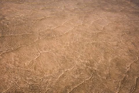Pattern of small sea waves shining in sunlight Stock Photos