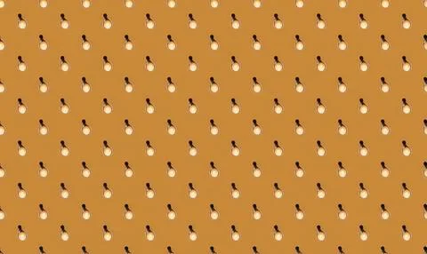 Pattern of small white and black light bulbs on brown background Stock Illustration