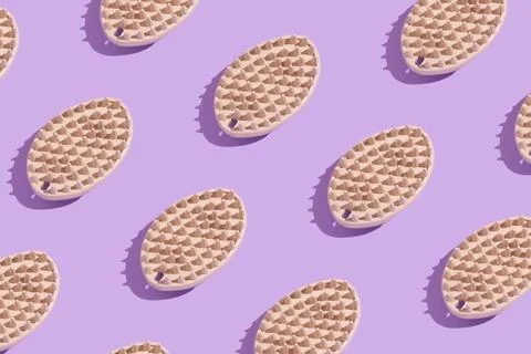 Pattern of soft brush for combing hair from pets on a purple background Stock Photos