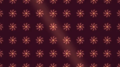 Pattern of spinning flowers in warm tones on dark Stock Footage 338204033