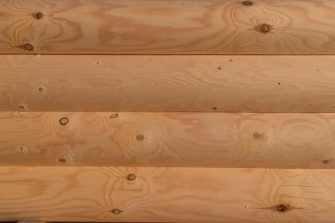 Pattern stack of round timber logs for building wooden house. Removing bark from Stock Photos