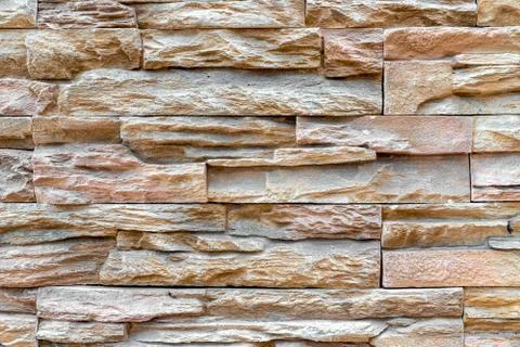 Pattern of stacked stone wall or brick wall texture background. Photos